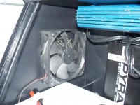 120mm Computer Chassis Fan used to cool / ventilate the box. Put a plastic shield on outside, over the metal grill, just to shield from light rain if that every happens again in Texas